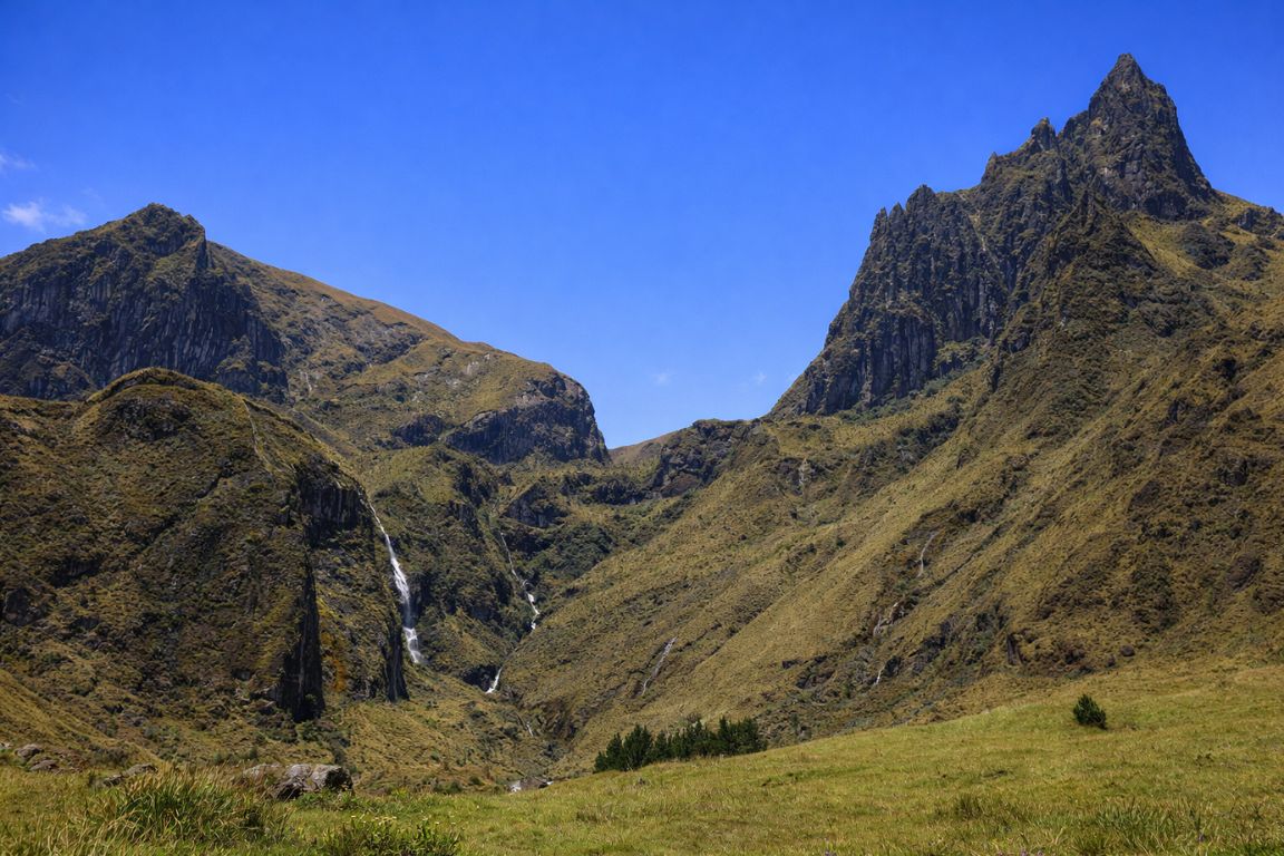 Andes highland valley with rocky peaks and alpine grasslands captured on El Altar Ecuador Tours